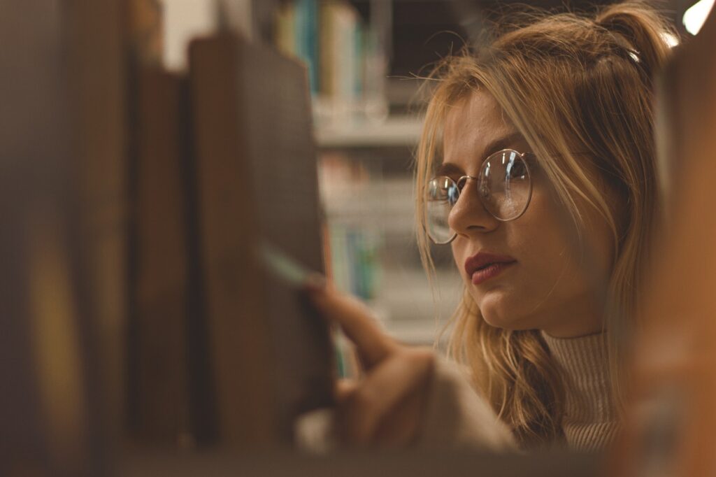 A student looking for a book at the library.