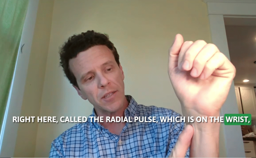 Dr. Luke Voytas, pointing to his wrist to show where the radial pulse can be felt.