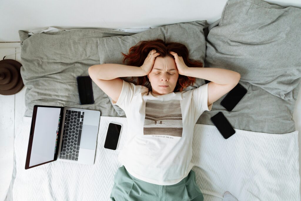 A high school student stressed from all of the technology and information they are taking in.